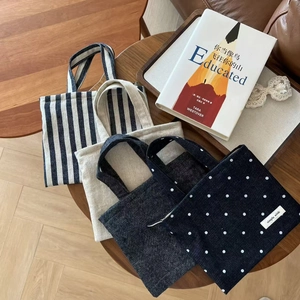 Retro canvas mini tote bags in striped, polka dot, and denim patterns on wood