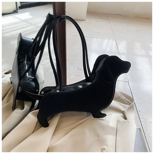 Detail showing back zipper and matte leather texture of the black dachshund dog shoulder bag