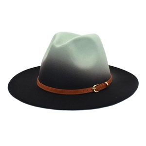 Detail of mint green gradient felt fedora hat featuring a brown faux leather buckle belt