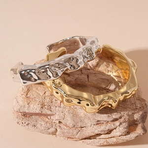 Minimalist wrinkled metal open cuff bracelets in polished gold and silver finishes