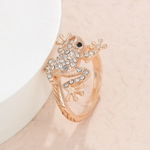 Detailed view of frog ring with sparkling crystals and engraved rose gold band