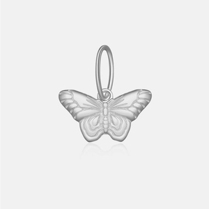 Macro shot of polished silver butterfly pendant with detailed wings and elegant engraving