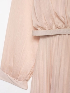 Detail of pink pleated midi dress with long sleeves and matching embossed waist belt