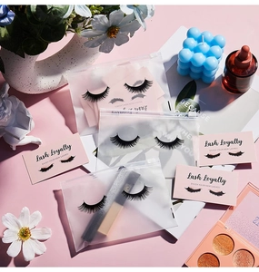 Detailed flat lay of pink EVA lash zipper bags with eyelash sets and loyalty cards