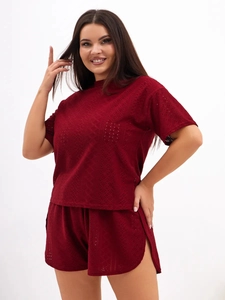 Detail of burgundy lace loungewear set featuring hollow-out texture and side slit shorts