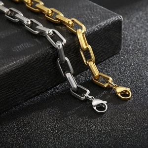 Detail of titanium steel curb chain bracelets in gold and silver with lobster clasps
