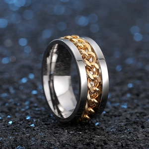 Detailed close-up of two-tone stainless steel ring with golden Cuban chain texture detail