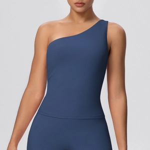 Detail of navy blue one-shoulder yoga top showing elastic quick-dry fabric and slim fit