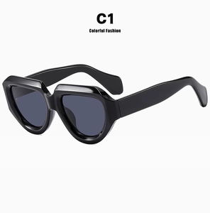 Detail view of bold irregular black vintage sunglasses with a glossy fashion finish
