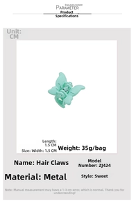 Detail view of a mint green butterfly mini hair claw clip made of matte finish metal