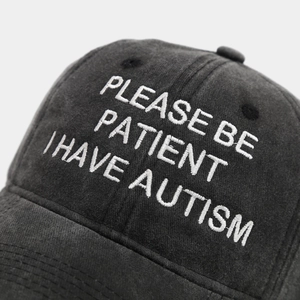 Detail of 3D embroidery on washed cotton baseball cap with vintage distressed texture