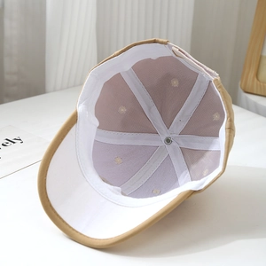 Internal view of khaki cotton baby baseball cap showing white lining and neat stitching