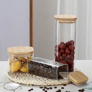 Three square borosilicate glass storage jars with bamboo lids in various sizes for food