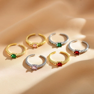 Adjustable gold and silver rings set with colorful oval zircons on champagne silk