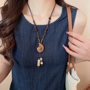 Ethnic style pearl flower pendant necklace with brown cord, wood beads and tassel detail