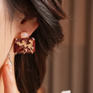 Vintage enamel geometric plum blossom earrings with red glaze and gold floral relief