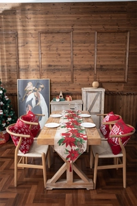 Detailed close-up of festive red Christmas table runner and cushions with snowflake patterns