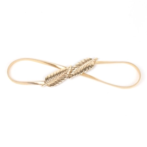 Detail showing elegant gold feather leaf buckle and elastic metal chain on waist belt