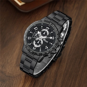 Detail of black metal strap watch with complex dial and calendar on wood background