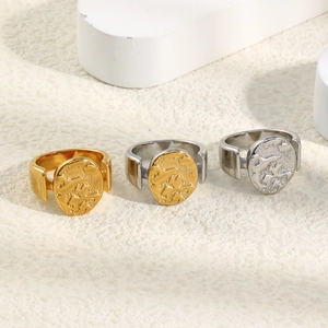 Detailed view of 18K gold plated stainless steel rings with abstract nebula relief texture