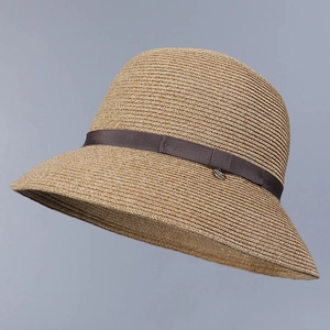 Close-up detail of Japanese-style straw sun hat with a decorative brown ribbon band