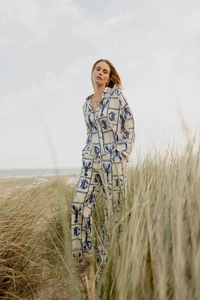 Women's beach vacation set featuring blue lobster print on cream long sleeve shirt and trousers