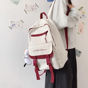 Side view of cream and burgundy high-capacity school backpack with stylish buckles