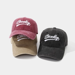 Detailed embroidery of Brooklyn text on washed cotton baseball caps in multiple colors