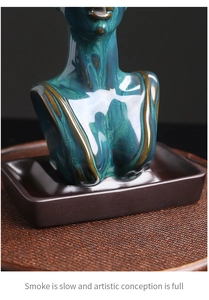 Macro detail of female torso ceramic incense burner with cyan flowing glaze finish