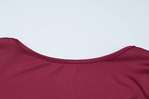 Detail view of the round neckline and double-stitch sewing of this wine red dress