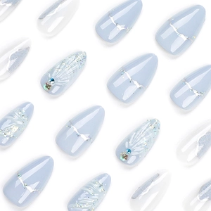 Almond-shaped light blue press-on nails with 3D shell patterns and glitter details