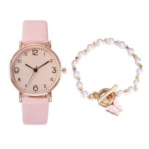 Pink leather strap watch with rose gold case paired with a white pearl butterfly bracelet