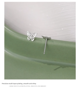 Close-up of S925 sterling silver butterfly stud earrings with hollow design details