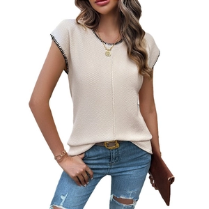 Women's chic beige sleeveless knit sweater with black contrast stitching and textured fabric