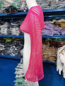 Dettaglio della maglia traforata color rosa acceso che mostra la trama su un manichino