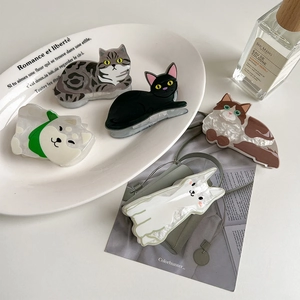 Cute acetate cat and dog hair claws in various animal designs shown on a decorative tray
