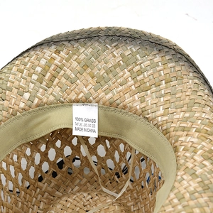 Detailed inner view of straw cowboy hat showing 100% grass material and sweatband