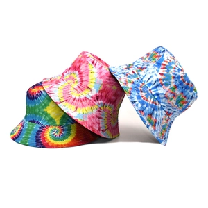 Three tie-dye reversible bucket hats in vibrant rainbow colors on a white background