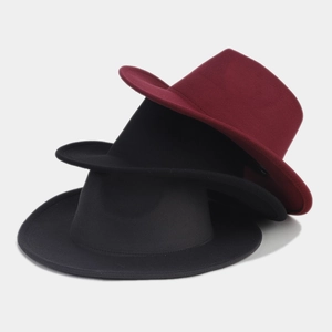 Close-up of three classic wool felt fedora hats in burgundy, dark grey, and black colors