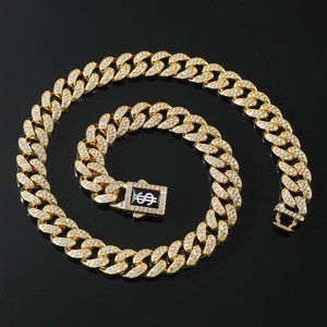 Macro shot of gold-plated Cuban chain with sparkling rhinestone dollar sign buckle