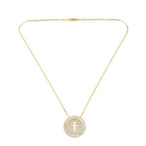Detail of gold circular pendant necklace with hollow cross and sparkling cubic zirconia