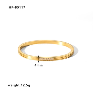 Detail view of 4mm gold stainless steel bracelet showing weight and zircon row