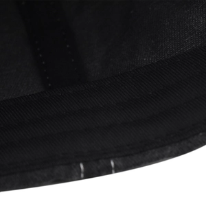 Close-up of fine machine stitching and twill fabric texture on a washed cotton cap
