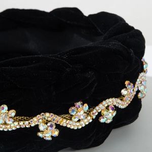 Macro view of braided black velvet headband with sparkling rhinestones and gold chain