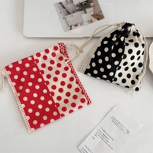 Detailed view of polka dot drawstring storage bags with poetic aesthetic postcards
