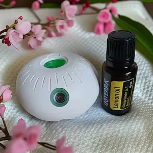 Waterless essential oil diffuser with 15ml lemon oil on a white waffle towel background