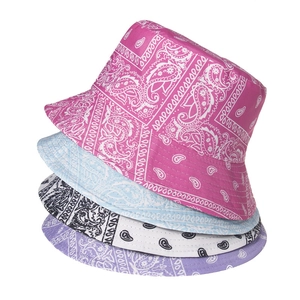 Close-up of paisley pattern detail on colorful bucket hats in pink, blue, and white