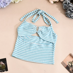 Detailed view of blue and white striped halter knit crop top on a beach-themed setup