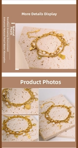 Detailed close-up of gold layered bracelet featuring natural pearls and symbolic charms