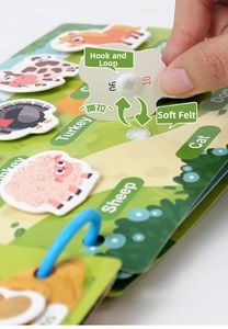 Detail of velcro hook and loop mechanism on kids' educational quiet book with animals